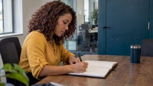Agent planning her workweek in a planner